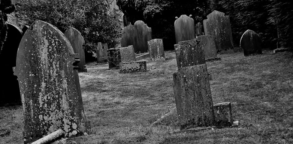 black and white photo of a cemetary with old grave stones