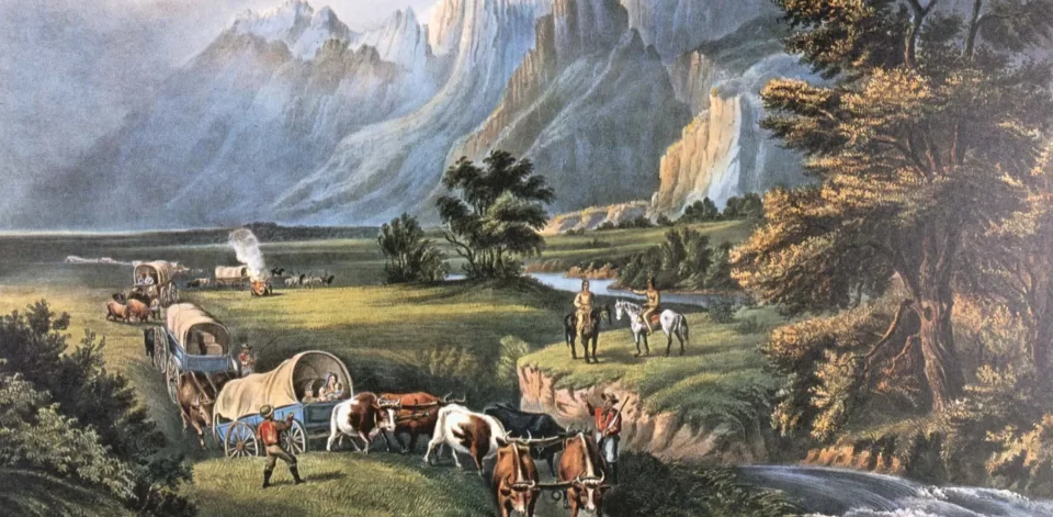 Covered wagons cross a grassy plain with oxen, framed by trees, a stream, and towering mountains, as two Indigenous men on horseback watch from afar