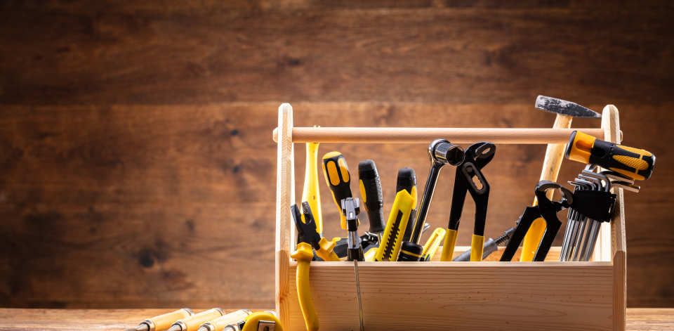 image of a wooden toolbox with tools inside